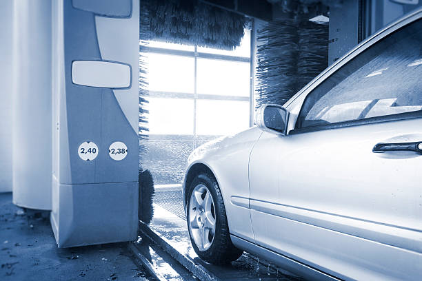 Automatic wash blue brush in action, white car comes out ready clean