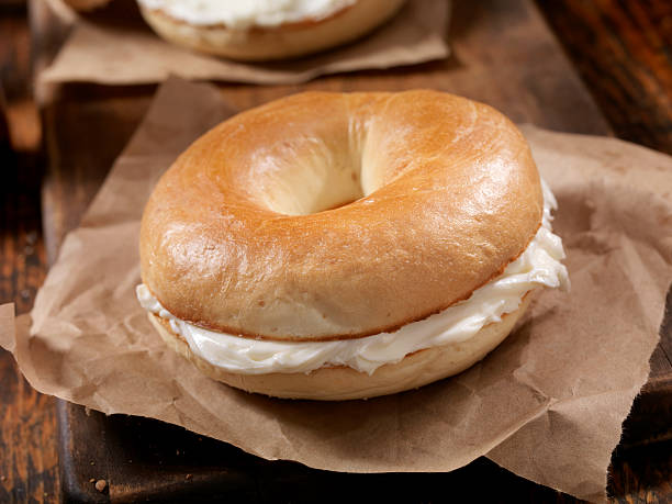 Bagel and Cream Cheese Toasted New York Style Bagels with Cream Cheese - Photographed on a Hasselblad H3D11-39 megapixel Camera System cream cheese stock pictures, royalty-free photos & images