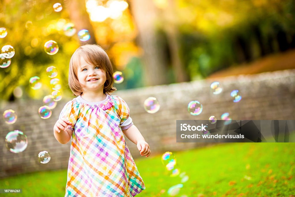 Happy Girl Standing Around Bubbles Close-up Of Smiling Little Standing Around Bubbles In Garden Bubble Wand Stock Photo