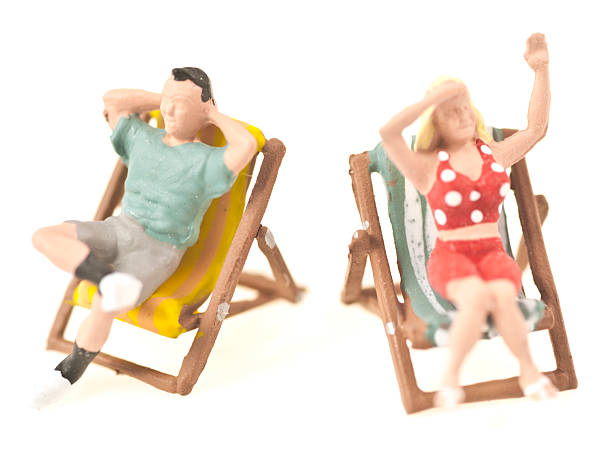 istock two little people in desk chairs 187184475
