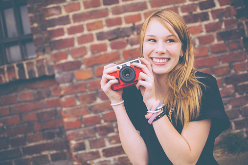 Beautiful Young Woman Holding Red Vintage Camera