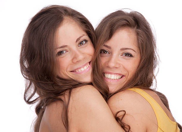 istock Two girls sisters - GEMINI on a white background 187186002