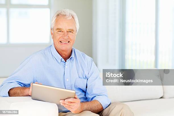 Senior Man With Digital Tablet Smiling At Home Stock Photo - Download Image Now - 60-64 Years, 60-69 Years, Active Lifestyle