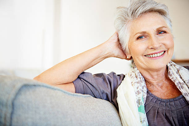 Feeling content with her life Smiling senior woman relaxing at home 65 69 years stock pictures, royalty-free photos & images
