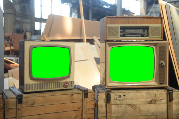 istock Two old green screen TVs in a hangar. 1871863244