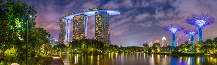 The futuristic towers of Marina Bay Sands illuminated at night, Singapore.