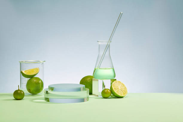 istock Laboratory beaker, Erlenmeyer flask, glass rod, glass platform and fresh lemon stand out against the fresh blue background. Display products with ideal space. 1871884248