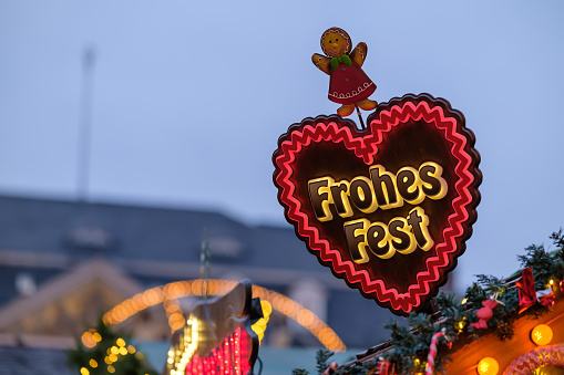 View of a heart shaped Frohes Fest sign, Happy Holidays and Merry Christmas at the Christmas Market in Bonn Germany