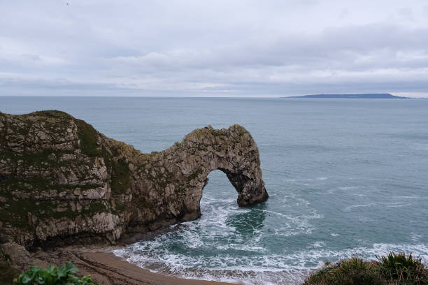 Durdle Door limestone arch on the Jurassic Coast in Dorset. Natural landmark. England. Pure clean clear water