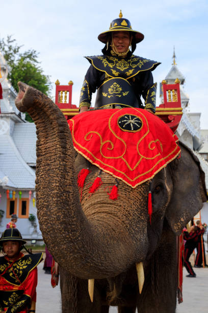 Lampang, Thailand - December 2, 2023: Traditional ceremony with elephants and Thai soldiers dressed in the Royal costume celebrating the former King Mengrai of Lanna.