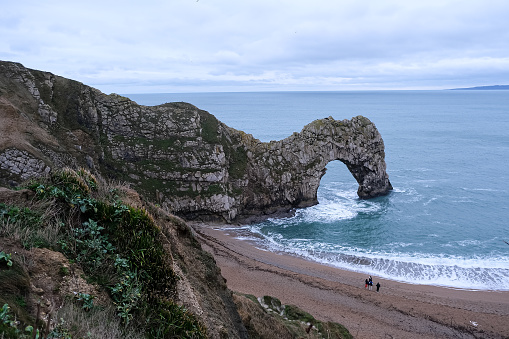 Durdle Door limestone arch on the Jurassic Coast in Dorset. Natural landmark. England. Pure clean clear water