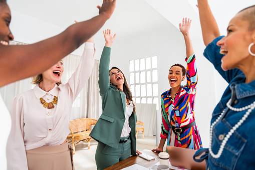 Group of beautiful confident businesswomen meeting in the office - Multiethinc female creative team brainstorming at work - Diverse colleagues working together  in workshop  in a co-working space