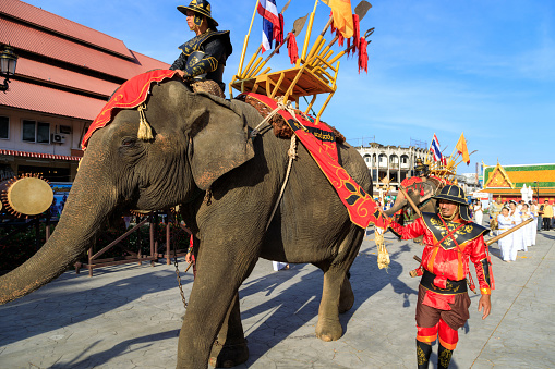 Lampang, Thailand - December 2, 2023: Traditional ceremony with elephants and Thai soldiers dressed in the Royal costume celebrating the former King Mengrai of Lanna.