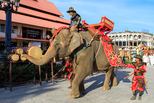 Lampang, Thailand - December 2, 2023: Traditional ceremony with elephants and Thai soldiers dressed in the Royal costume celebrating the former King Mengrai of Lanna.