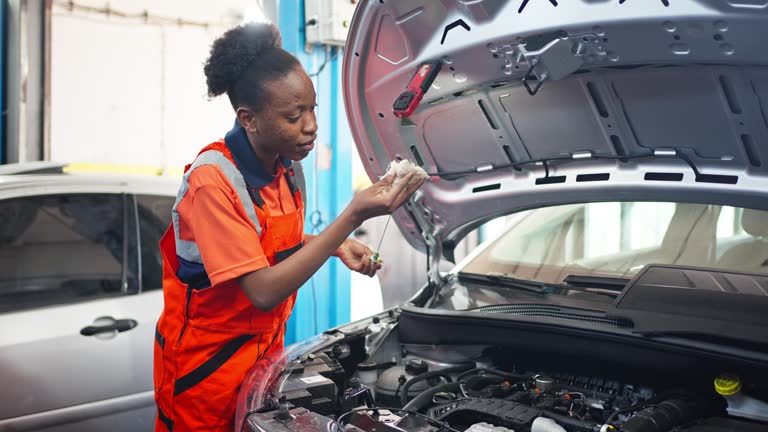 Black Mechanic woman working in the garage, Service and maintenance and car maintenance