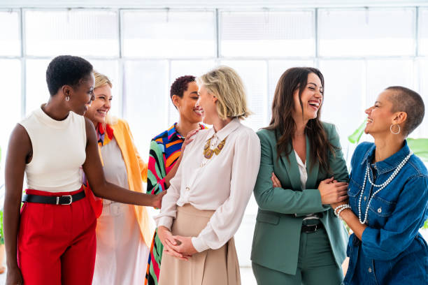 Group of businesswomen meeting in the office Group of beautiful confident businesswomen meeting in the office - Multiethinc female creative team brainstorming at work - Diverse colleagues working together in workshop in a co-working space only women stock pictures, royalty-free photos & images