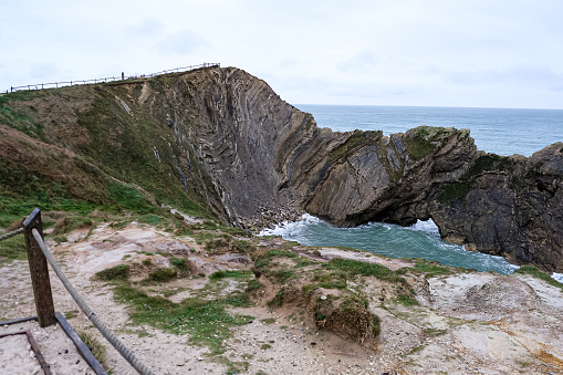 Jurassic coast view in Dorset at winter time. Cold winter day. Lulworth Cove cliffs view on a way to Durdle Door. The Jurassic Coast is a World Heritage Site on the English Channel coast of southern England. Dorset, UK. Stair Hole view.