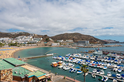 View of sea port and small bay of Puerto Rico de Gran Canaria holiday resort. Gran Canaria island, Spain