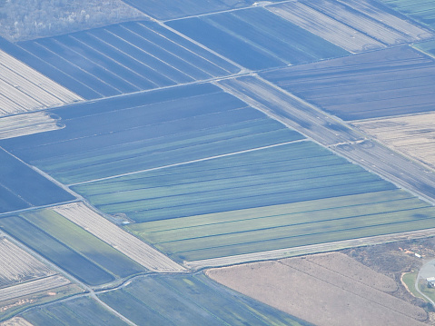 An aerial view of acres of farmland seen from an airplane.