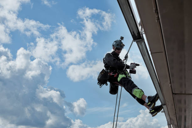 istock Industrial mountaineering worker hangs over residential building 1871975247