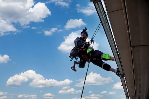istock Industrial mountaineering worker hangs over residential building 1871975251