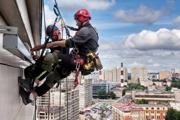 istock Industrial mountaineering worker hangs over residential building 1871975256