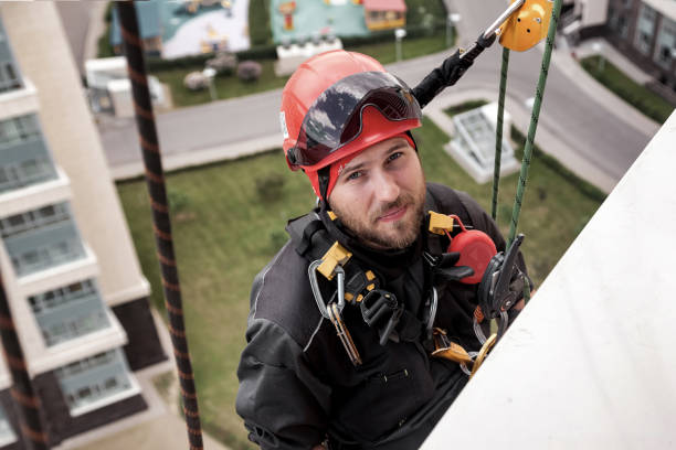 istock Industrial mountaineering worker hangs over residential building 1871975262