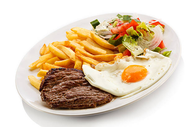 istock Beefsteak, fried egg, French fries and vegetables 187197895