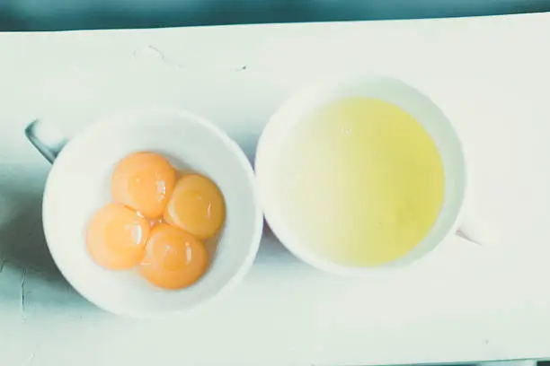 Photo of egg whites and yellows in seperate bowls