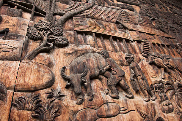 istock wood carving farmer in Thailand 187198612