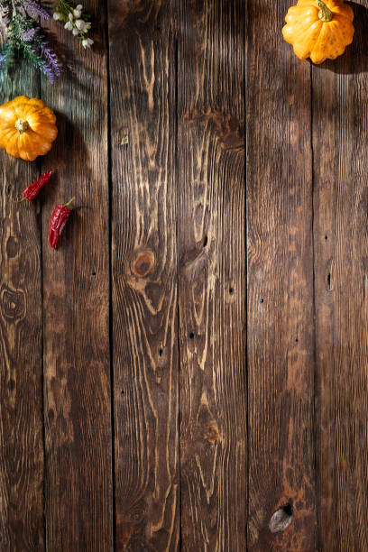 istock Rustic wooden backdrop featuring autumnal harvest elements, providing a warm, seasonal top view with space for text or design 1871989354