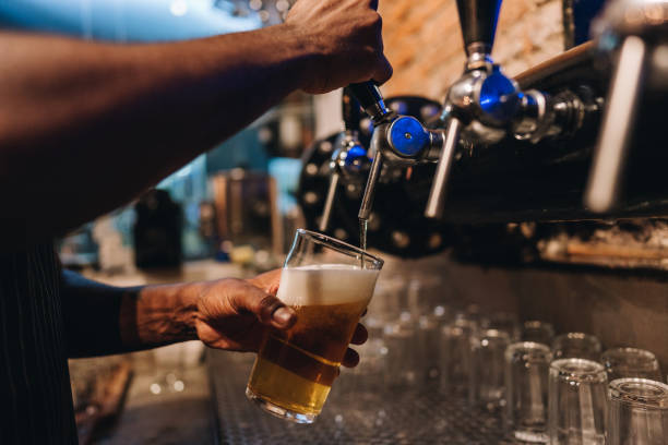 istock Close-up of a bartender pouring a draught lager beer 1871994203