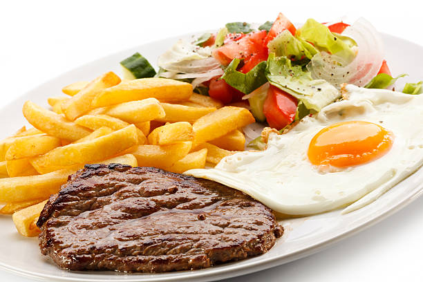 istock Beefsteak, fried egg, French fries and vegetables 187199788