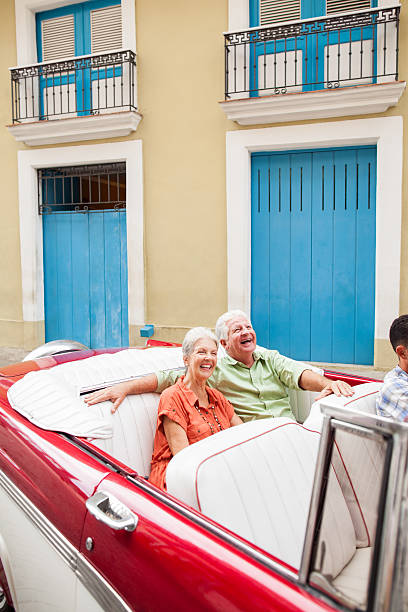 istock Excited couple riding a classic car 187199795