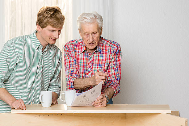 istock Collaboration: Grandfather and grandson assembling furniture 187199833