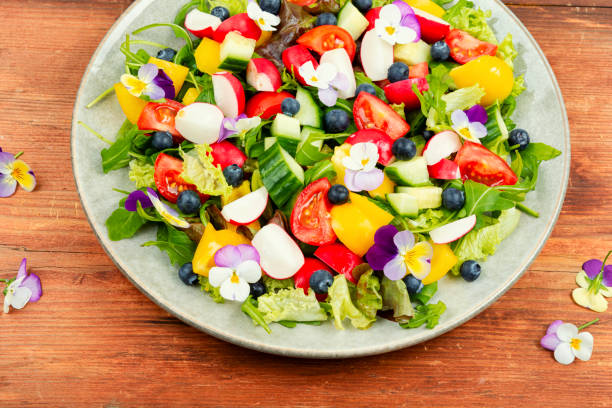 istock Spring salad with vegetables and flowers. 1872005509