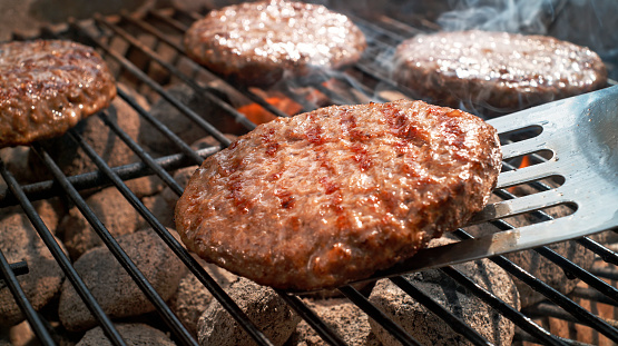 Close-up of meat roasting on barbecue grill.