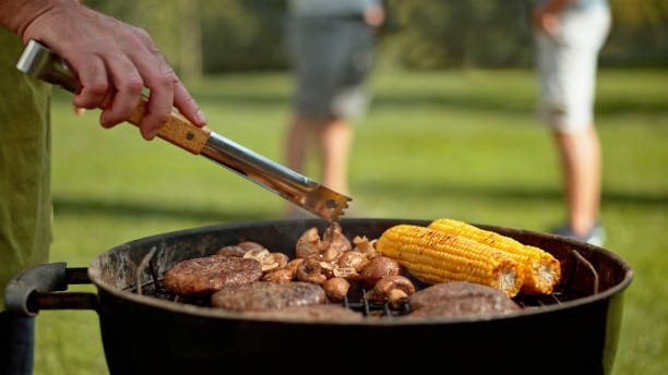 istock Male hand preparing food on grill 1872009663