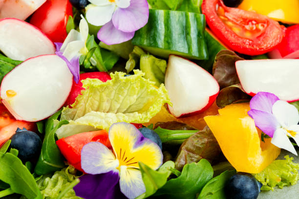 istock Spring salad with vegetables and flowers. 1872009675