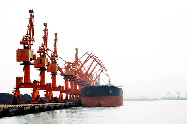 Coal loader a coal ship pumping out its ballast tanks whilst it is loaded with coal newcastle australia stock pictures, royalty-free photos & images