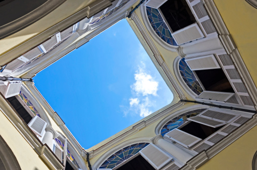 Many Cuban buildings are built as a quad with a courtyard in and open roof in the center.  Here we can see a shot looking up from the courtyard.