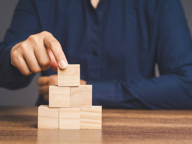 istock Businessman stacking blank wooden cubes on the table. 1872045566