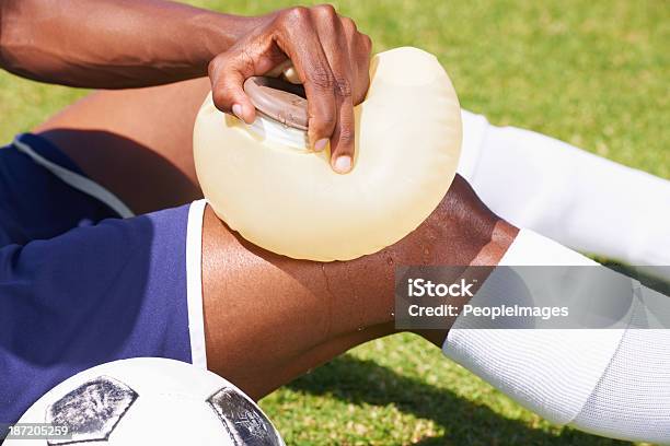 Tending An Injury Stock Photo - Download Image Now - Physical Injury, Soccer Field, African-American Ethnicity