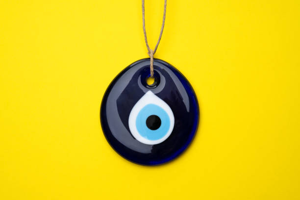 istock Big evil eye bead on yellow  background 1872061869