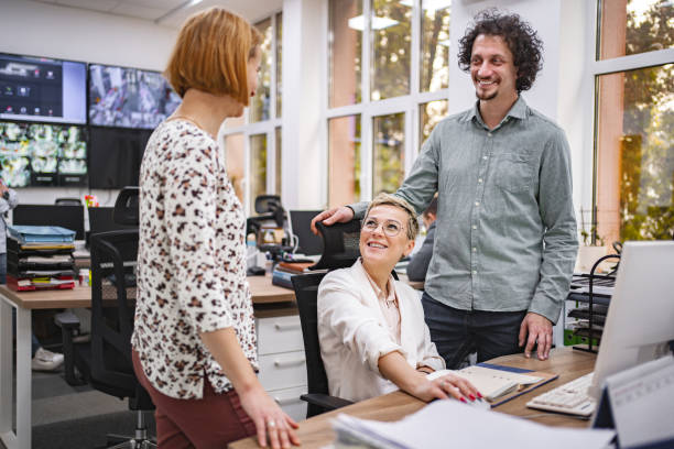 istock Three coworkers working together on a computer at the office 1872066805