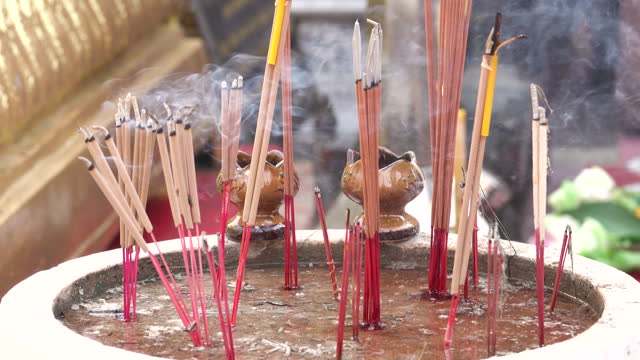 Close-up view of burning incense in temple