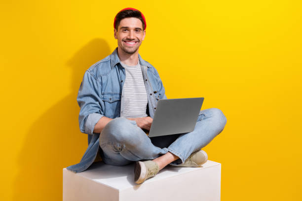 istock Photo of smart clever guy wear denim jacket communicating modern device empty space isolated yellow color background 1872073595