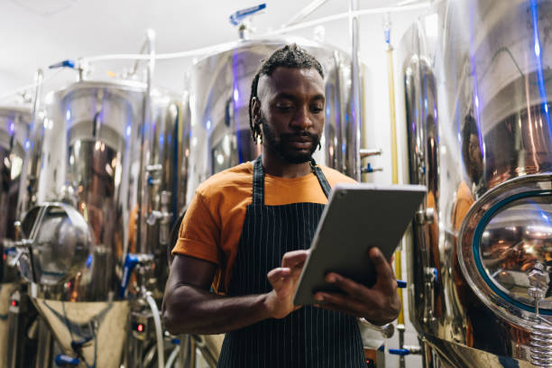 istock Mid adult man using digital tablet at brewery 1872076225