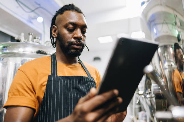 istock Mid adult man using digital tablet at brewery 1872076230