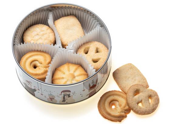 istock Metal box decorated with dolls plus sugary butter cookies, on a white background. 1872077276